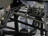 Steering linkage and pedals inside driver footbox